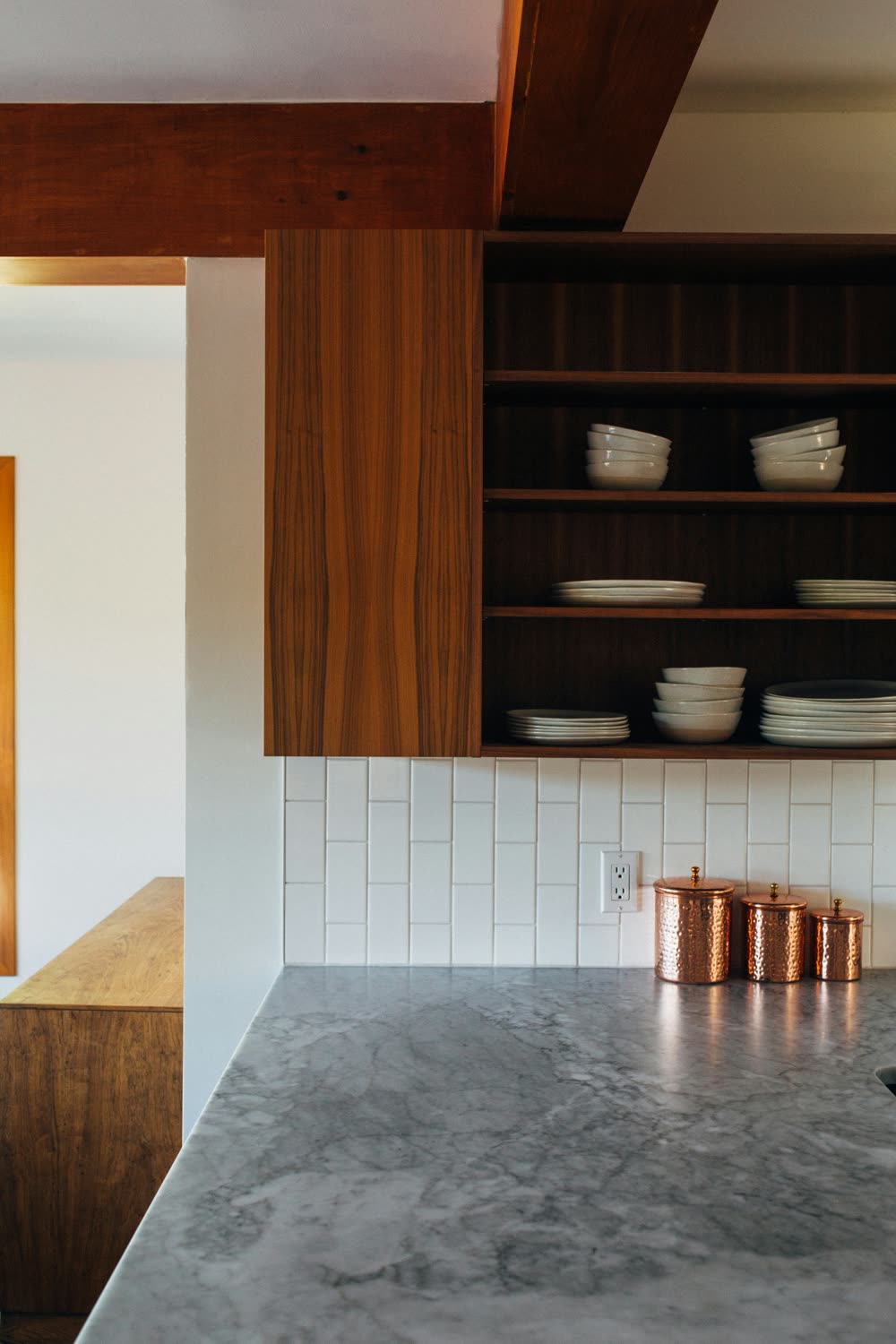 Stone countertop with walnut cabinetry
